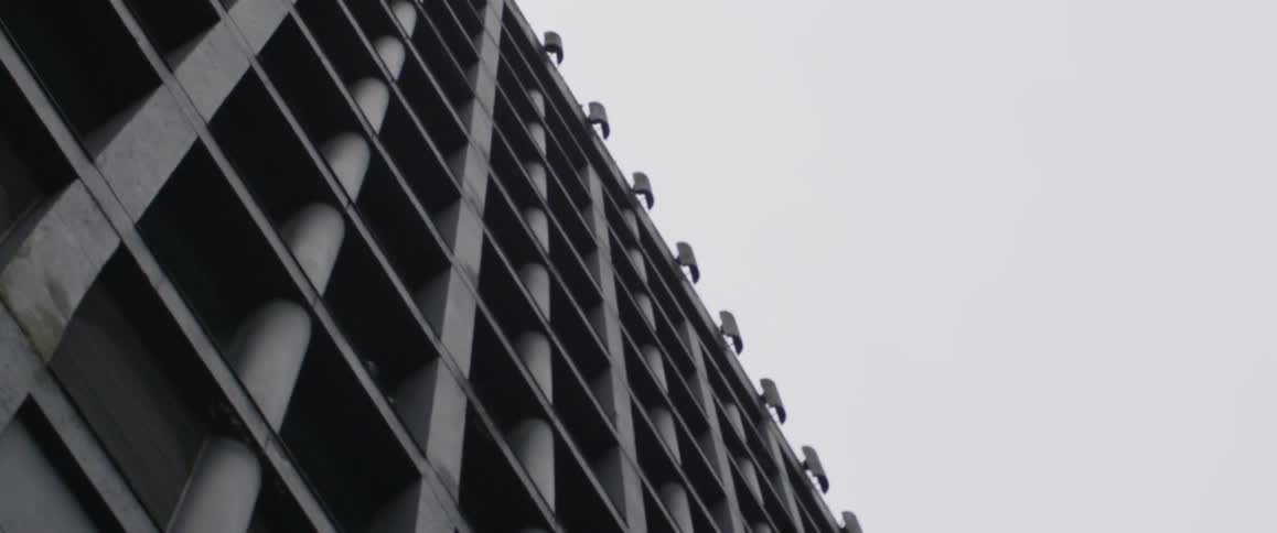 The tall building lines the cloudy sky