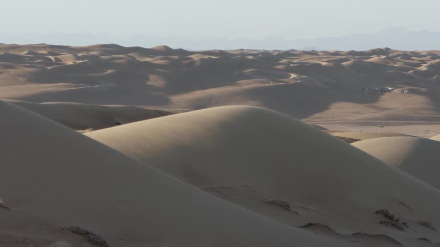 The sand dunes run into the distance
