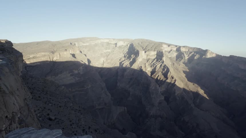 Mountains cover a large area under the blue sky