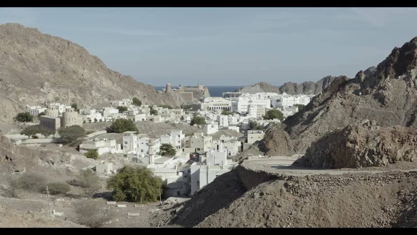 White buildings sit nestled in mountains