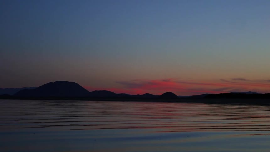 Calm surface of a lake at sunset