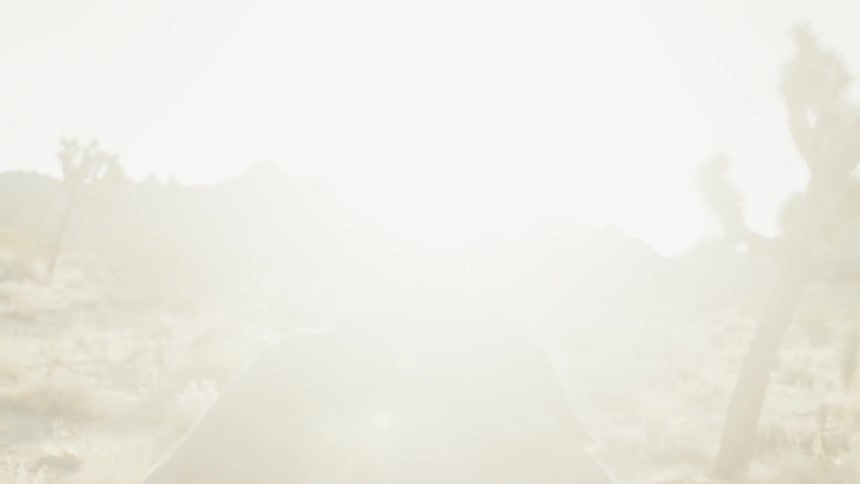 A man jogs through the desert in the sunrise