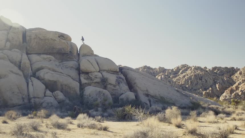 A man scrambles up a set of rocks at speed