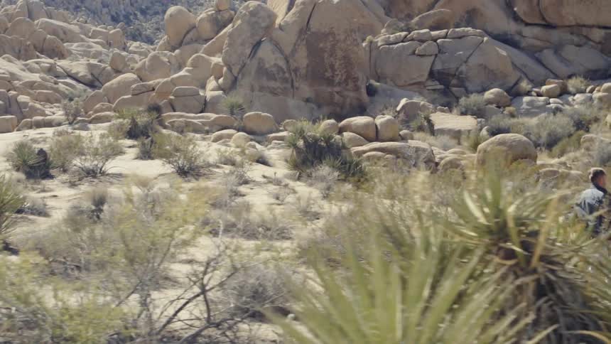A man is running by a mountainside