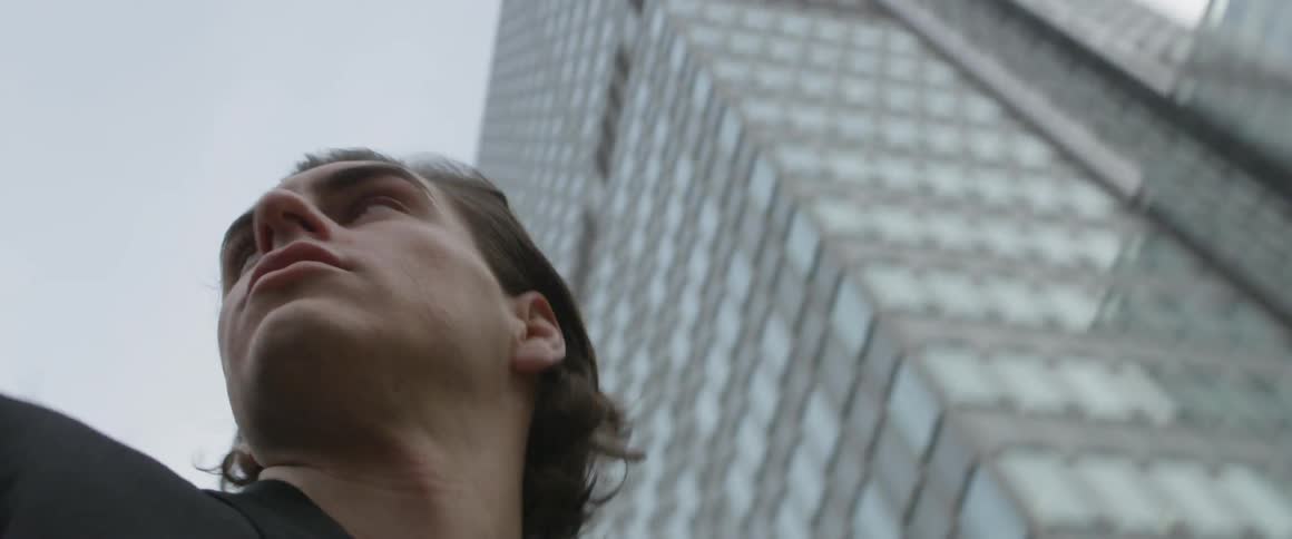 A man is outside looking around the city