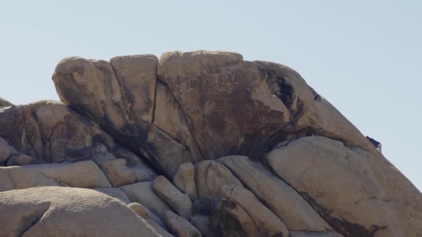 A man is climbing up the mountain