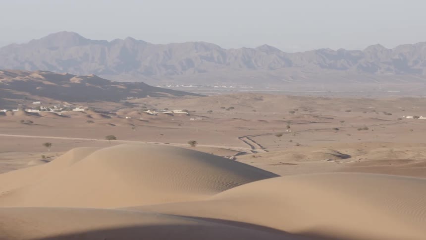 A vast desert sits undisturbed under the hot sun