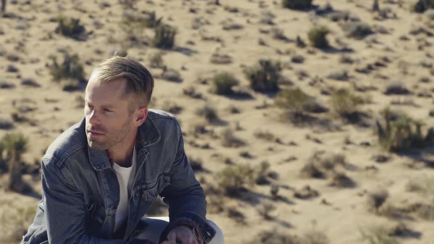 A man is outside in a desert area