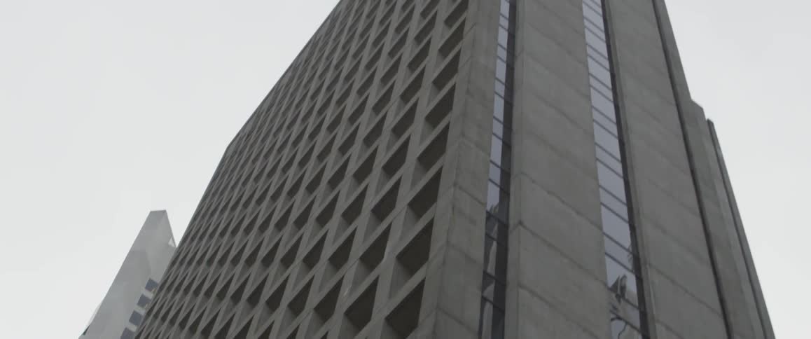 Buildings stand tall under a cloudy blue sky