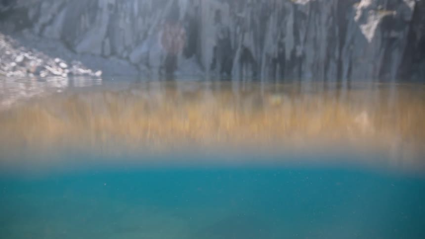Close up view of water and a mountain in the background
