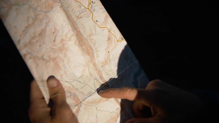 Person pointing at a map