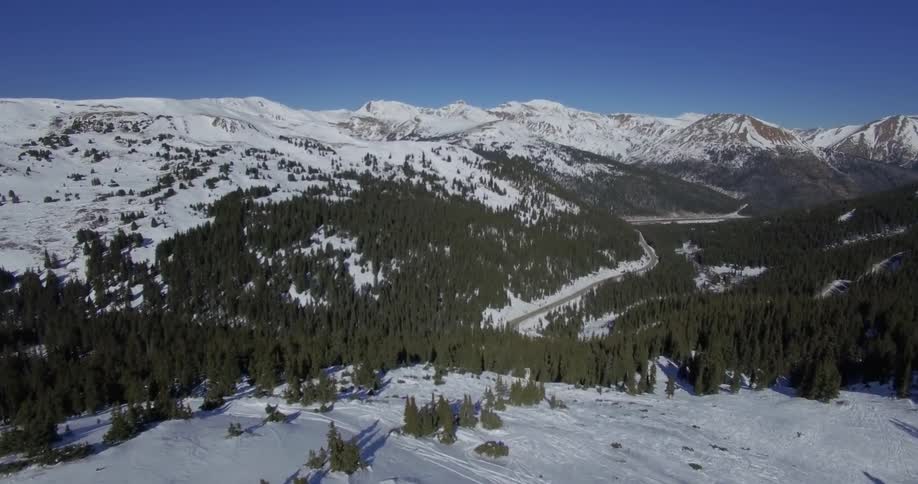 A snow covered mountain is flown over