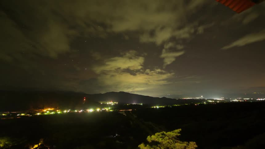 Clouds floating over a city area at night