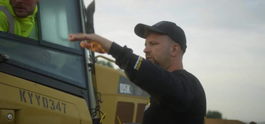 Man Motioning with his hand at Job Site