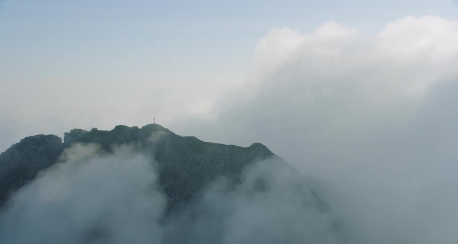 Clouds move to swiftly engulf the mountain top.beautiful shot
