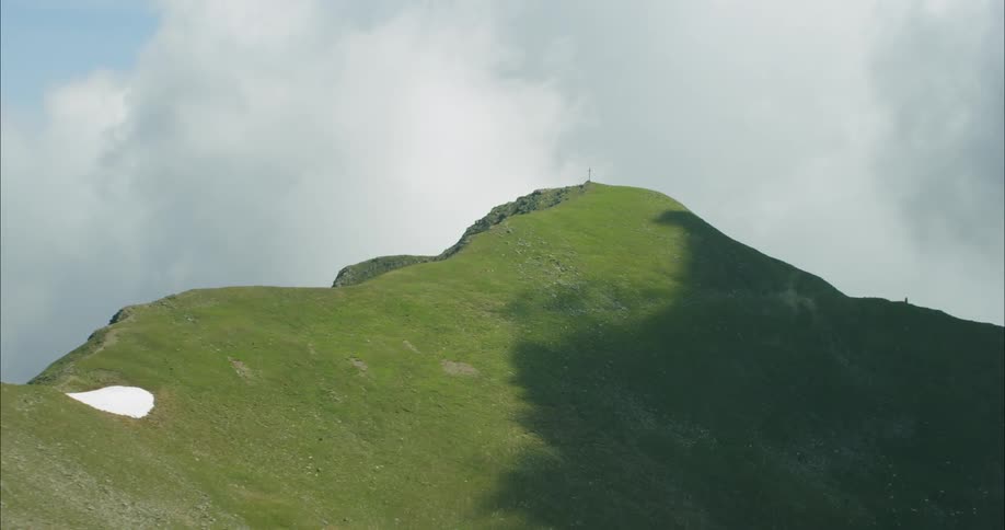 The mountain is covered with green grass