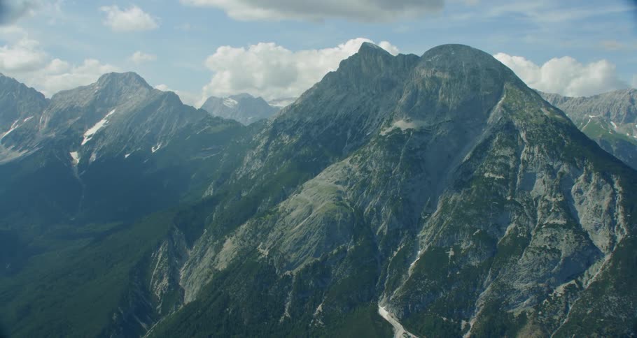 Dramatic mountain range with pine trees and rough peaks
