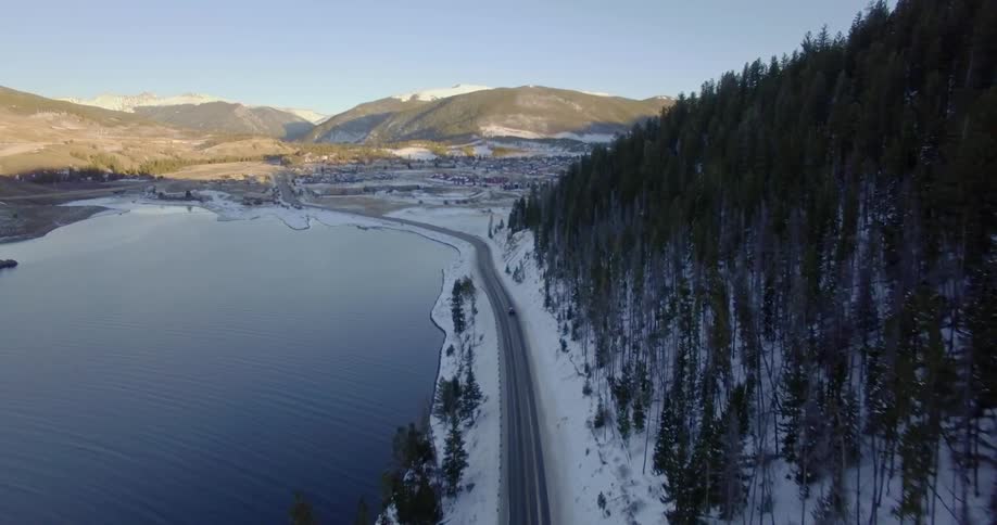 A scenery of a road near lake at winter season