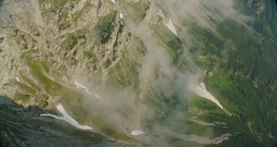 The mountain is covered with fog and some snow