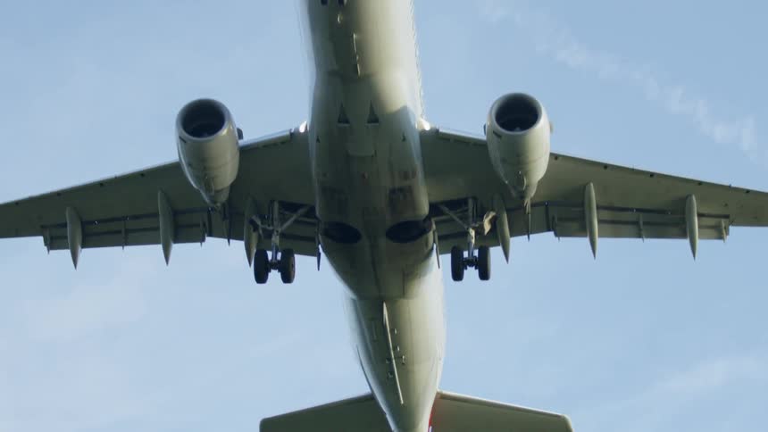 A jumbo jet with it's landing gear extended comes in for a landing