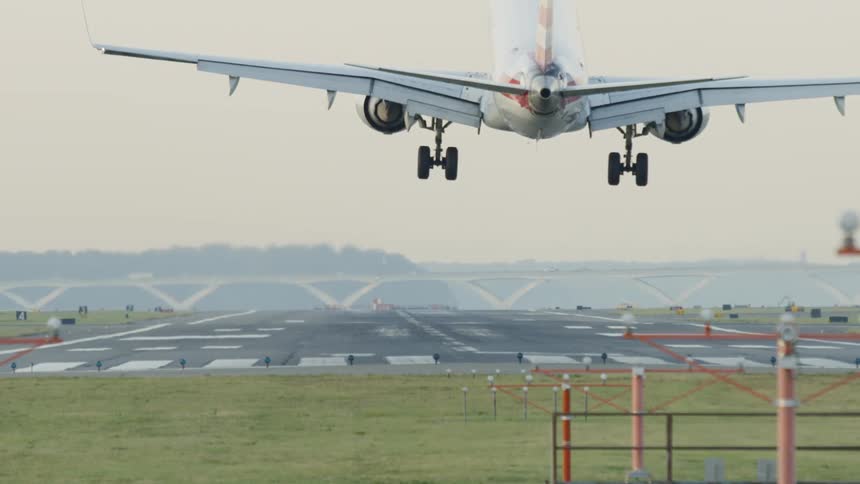 An airplane is landing outdoors