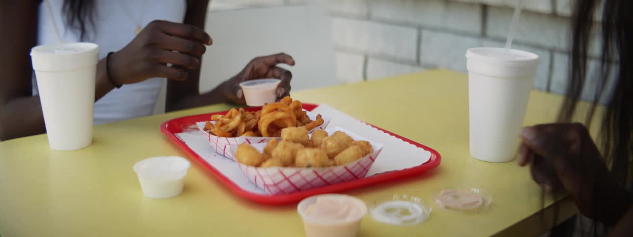 People are eating fried food at a restaurant
