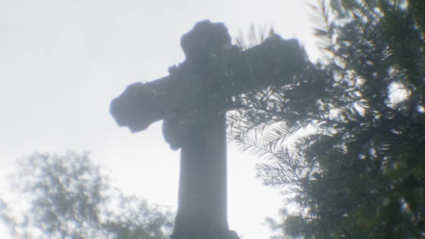 A statue of a cross is outside
