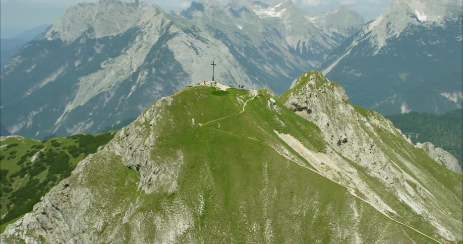 A mountain with a cross on its top
