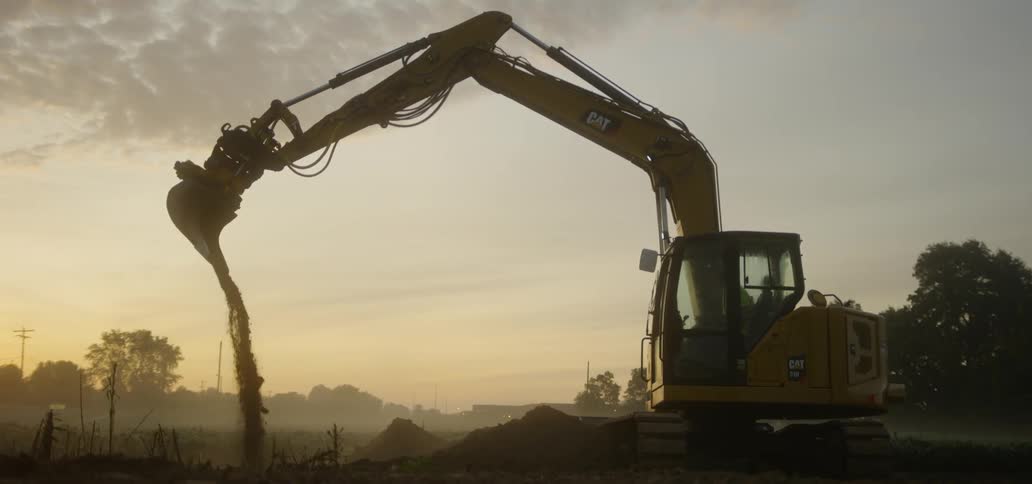 Excavator Digging at Sunrise