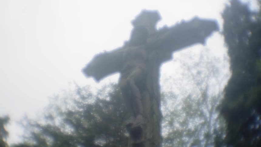 A statue of a cross is outside