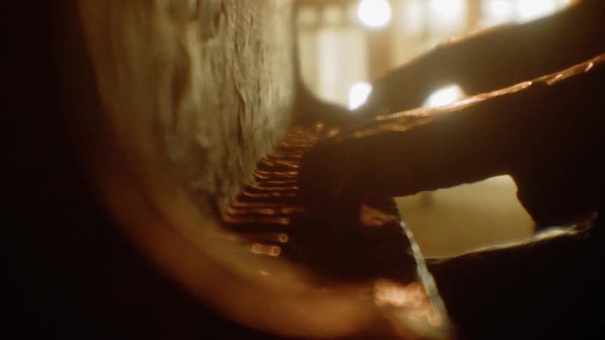 A statue of a person playing piano is in the hall