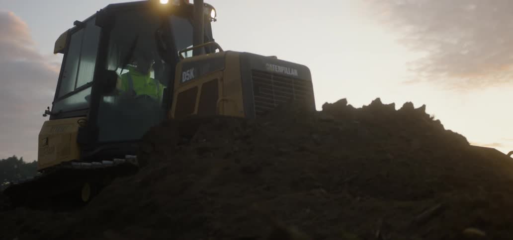 Front end loader pushing soil