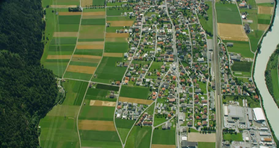 An aerial view of small agricultural towns inside a valley