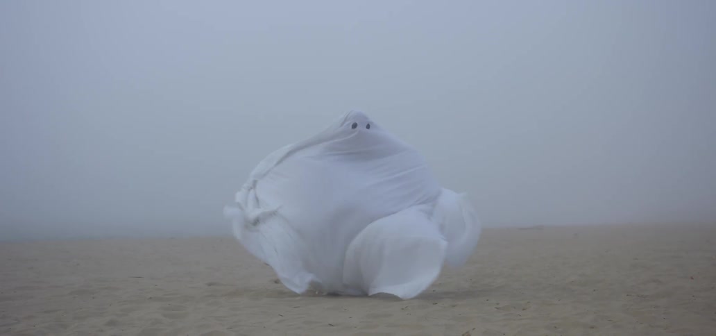 The sheet ghost is standing in the wind being blown and almost loses his footing