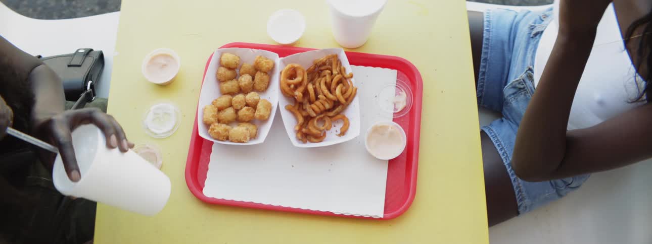A group of people eating fries