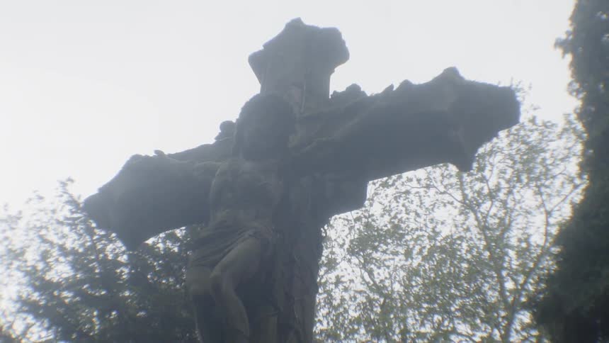 Statue of a crucifix in a cemetary