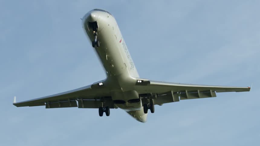 A plane is flying in the cloudy sky