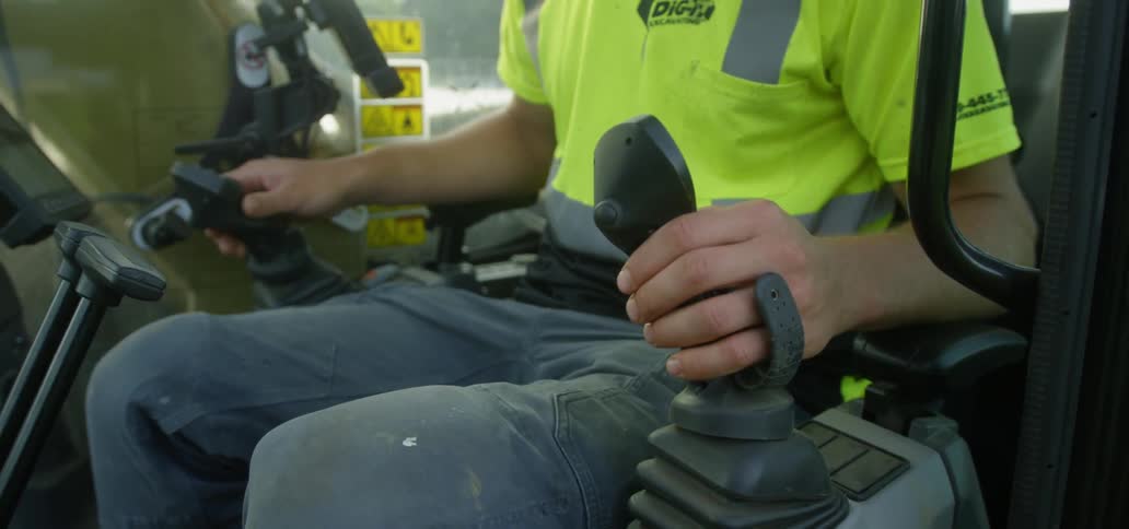 Man Operating Heavy Equipment On Construction Site