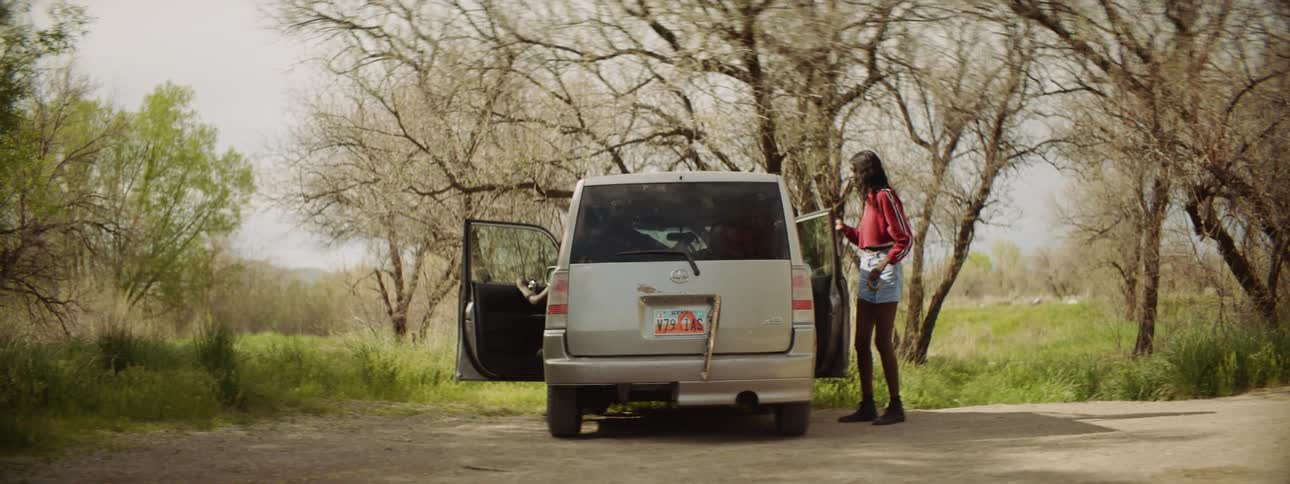 People get out of the vehicle by the field