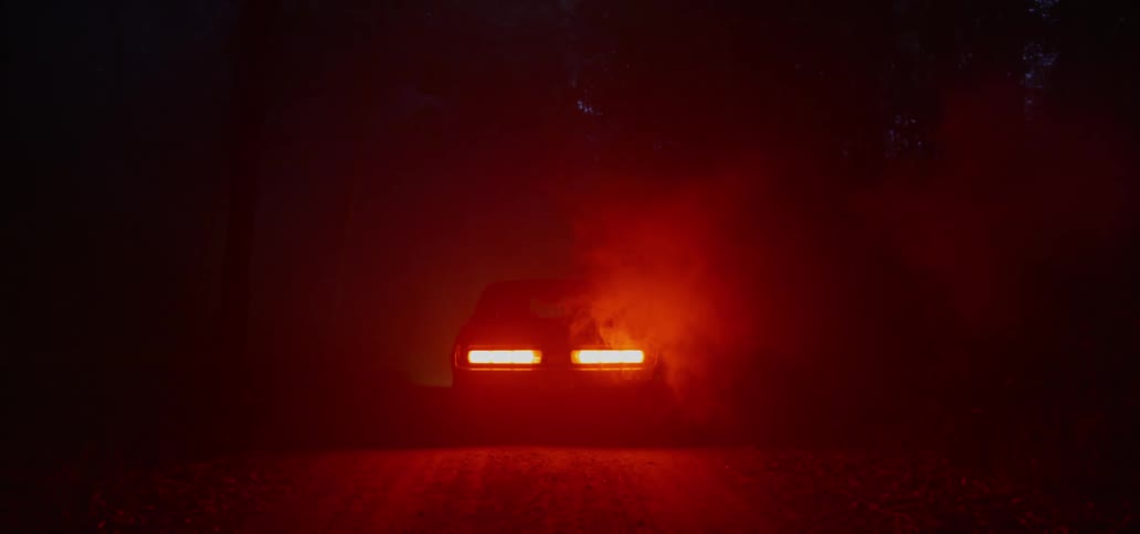 A vehicle starts on the dark rode