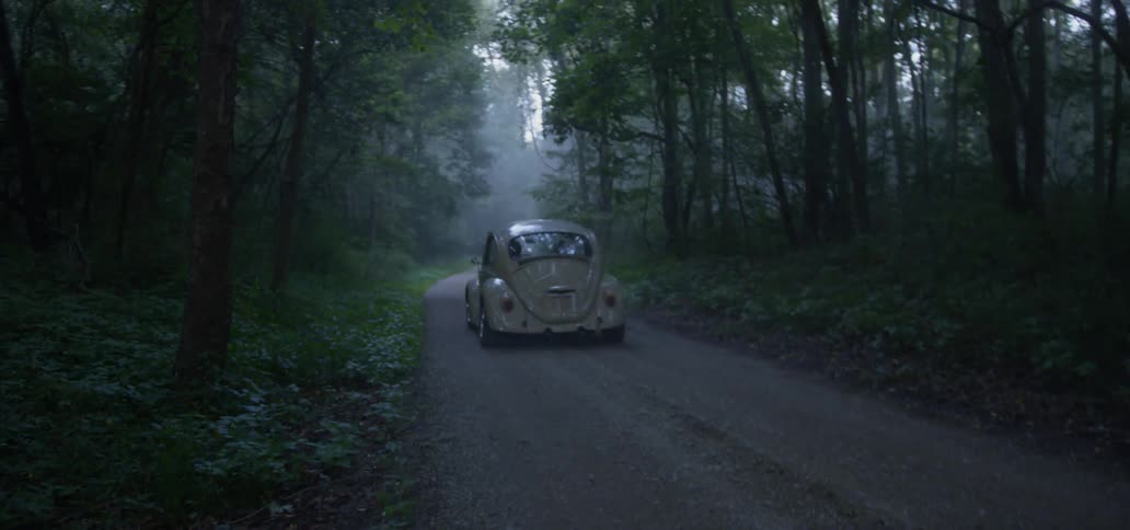 Vintage Car Driving Down Gravel Road