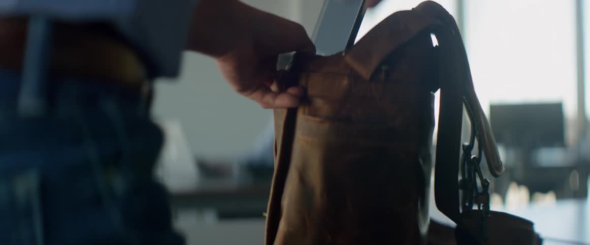 A person packing a backpack