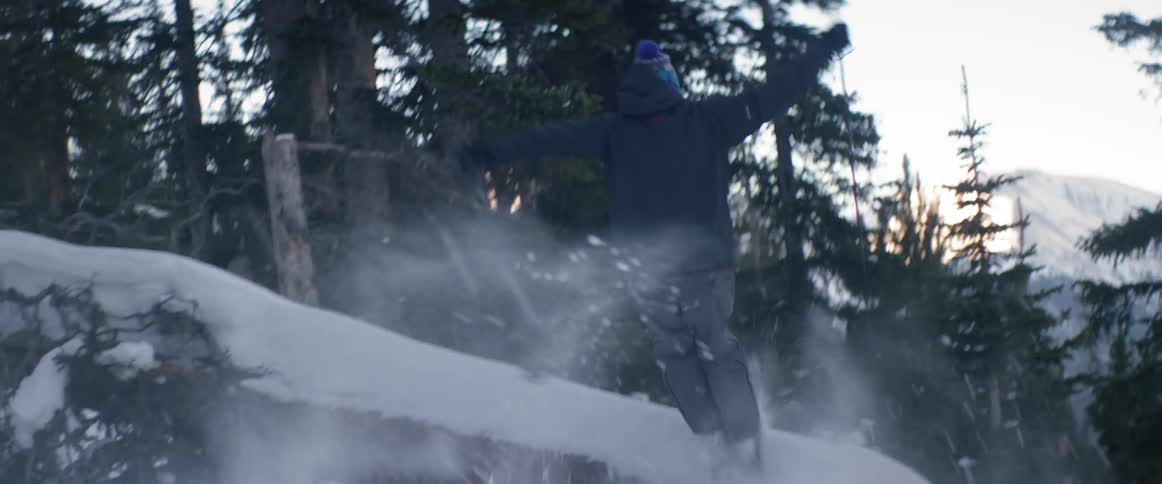 Someone on skis jumping from one boulder to another