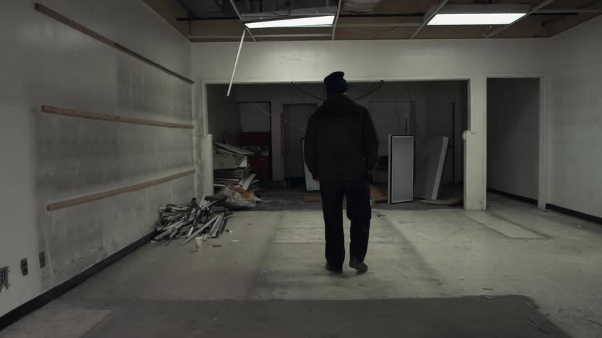 A man is walking around in a building