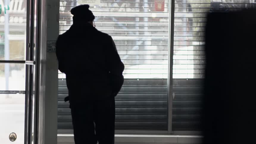 A person standing in front of a window