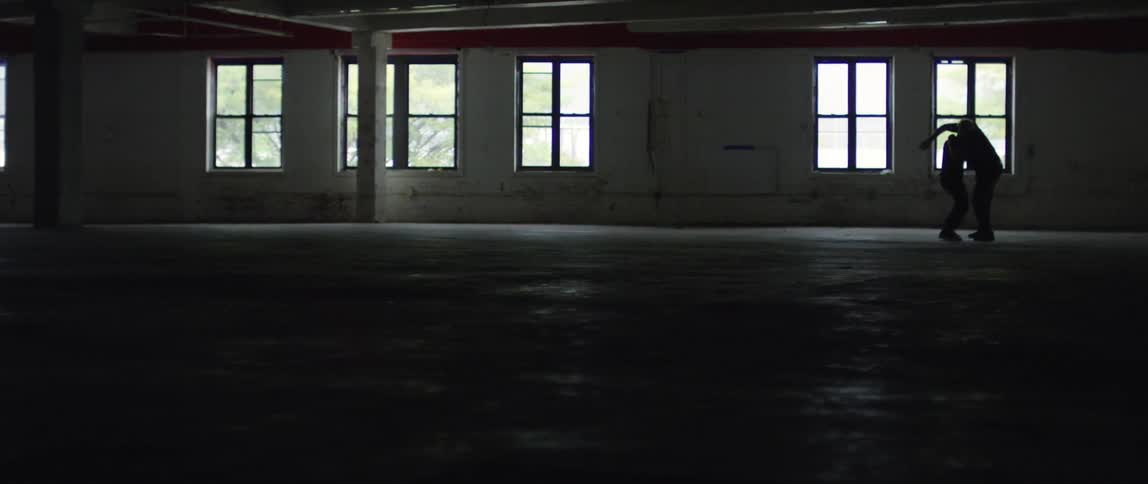 An empty warehouse with natural light coming in through the windows