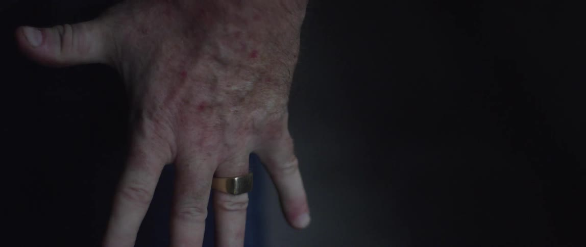 A man's fist flexing and then opening