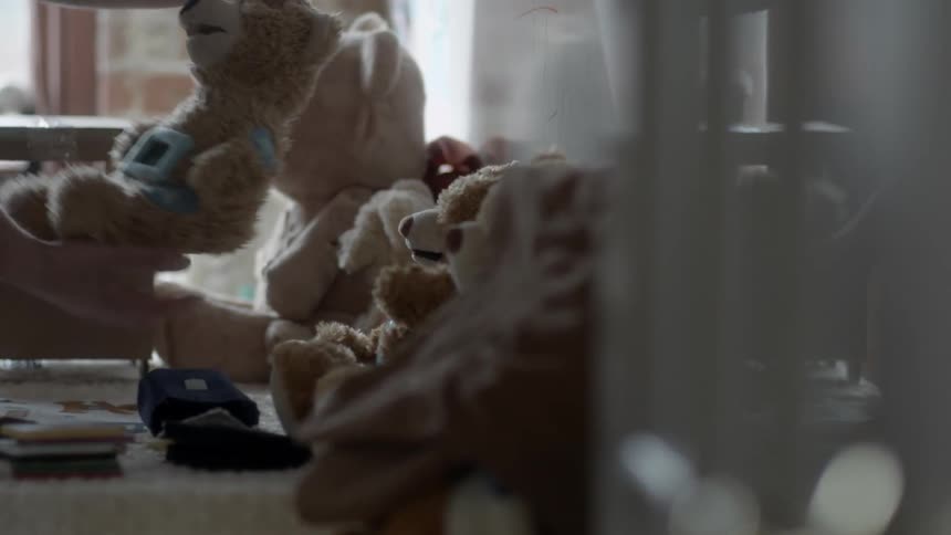 Man taking a toy out of a row of stuffed toys