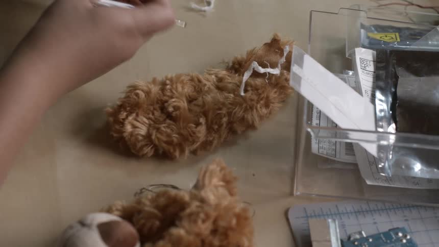 Someone constructing a teddy bear