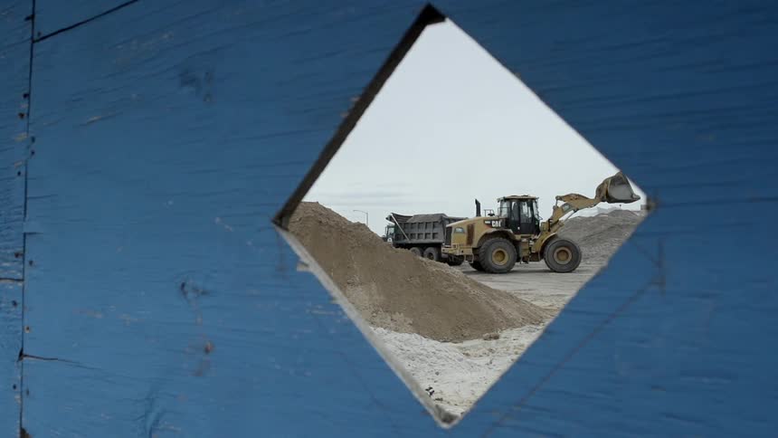 A truck is digging dirt